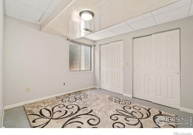 1202 Creekwood Ct, Windsor, CO 80550 - unfurnished bedroom featuring two closets, a drop ceiling, and baseboards