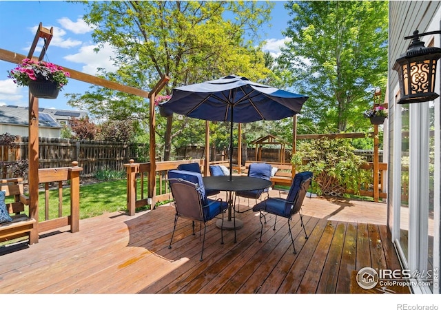 1202 Creekwood Ct, Windsor, CO 80550 - wooden deck featuring a fenced backyard and outdoor dining area