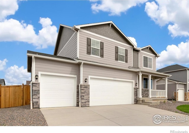 6300 Globeflower St, Wellington, CO 80549 - craftsman-style house featuring stone siding, concrete driveway, covered porch, and a garage