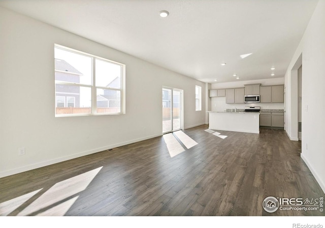 6300 Globeflower St, Wellington, CO 80549 - unfurnished living room with dark wood-type flooring, baseboards, and recessed lighting