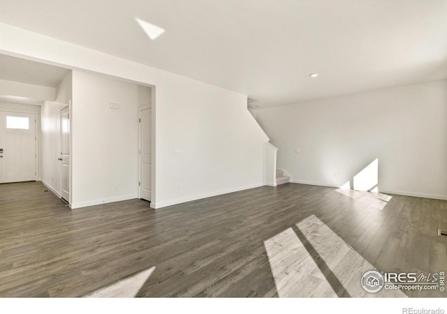 6300 Globeflower St, Wellington, CO 80549 - unfurnished living room with stairway, dark wood-style floors, baseboards, and recessed lighting