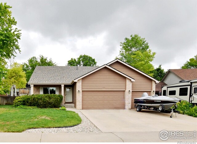 1131 Sandra Dr, Johnstown, CO 80534 - view of front of house with brick siding, a garage, and driveway