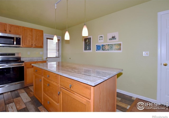 1131 Sandra Dr, Johnstown, CO 80534 - kitchen featuring appliances with stainless steel finishes, dark wood-style flooring, hanging light fixtures, a center island, and baseboards