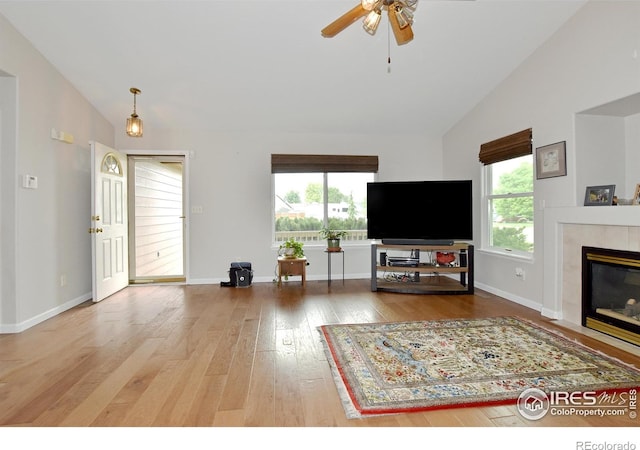 1131 Sandra Dr, Johnstown, CO 80534 - living area featuring wood-type flooring, ceiling fan, baseboards, a fireplace, and high vaulted ceiling
