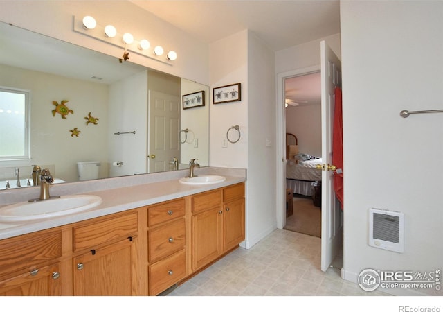 1131 Sandra Dr, Johnstown, CO 80534 - bathroom featuring ensuite bath, double vanity, heating unit, toilet, and tile patterned floors