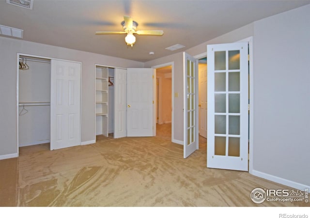 1131 Sandra Dr, Johnstown, CO 80534 - unfurnished bedroom featuring baseboards, carpet flooring, multiple closets, french doors, and a ceiling fan