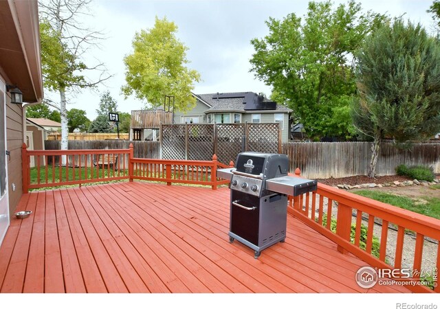 1131 Sandra Dr, Johnstown, CO 80534 - wooden deck featuring grilling area and a fenced backyard