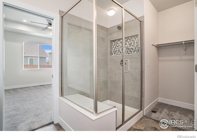 1211 104th Ave, Greeley, CO 80634 - bathroom featuring a stall shower, baseboards, a ceiling fan, a spacious closet, and recessed lighting