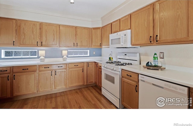4725 Spyglass Dr, Broomfield, CO 80023 - kitchen with white appliances, light countertops, and light wood-type flooring