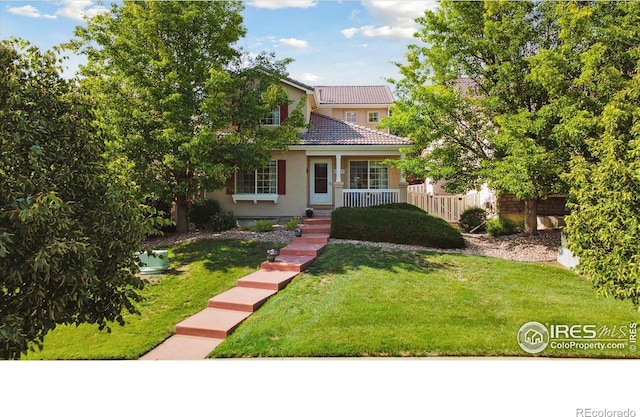 4725 Spyglass Dr, Broomfield, CO 80023 - view of front of property with a front yard, a tiled roof, stucco siding, and covered porch