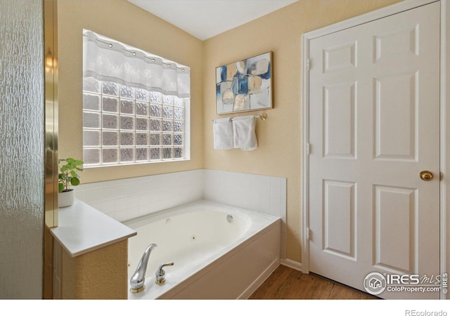 4725 Spyglass Dr, Broomfield, CO 80023 - full bathroom with a whirlpool tub, wood finished floors, and baseboards