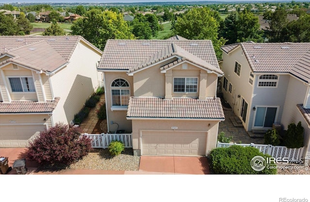4725 Spyglass Dr, Broomfield, CO 80023 - view of front facade with a garage, a tile roof, stucco siding, driveway, and a residential view