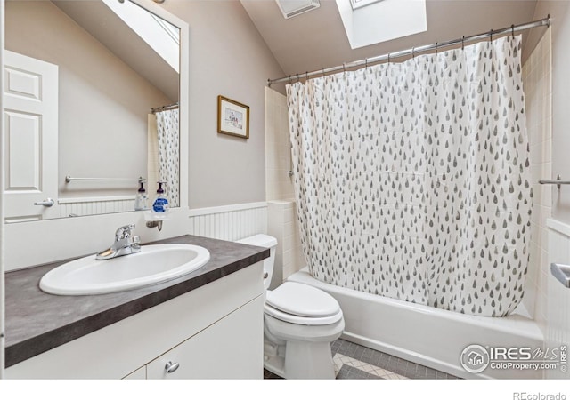 3561 4th St, Boulder, CO 80304 - bathroom featuring a skylight, vanity, shower / tub combo with curtain, toilet, and vaulted ceiling