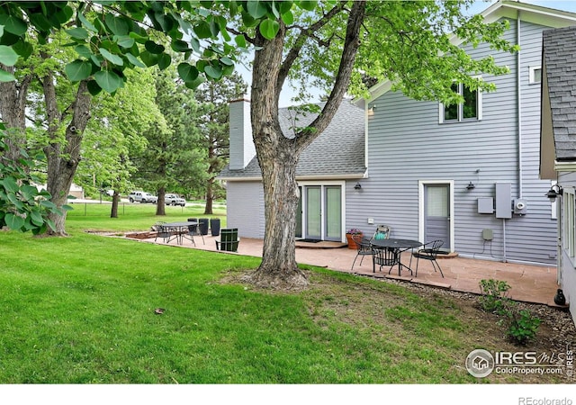 3561 4th St, Boulder, CO 80304 - rear view of property with a shingled roof, a patio area, and a lawn