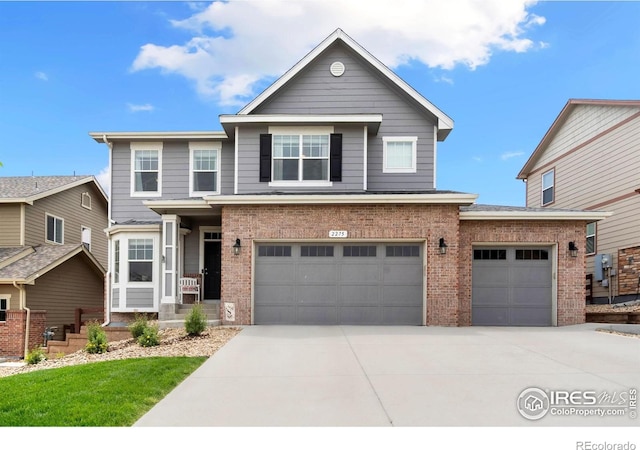 2275 Stonefish Dr, Windsor, CO 80550 - view of front of property with brick siding, driveway, and an attached garage