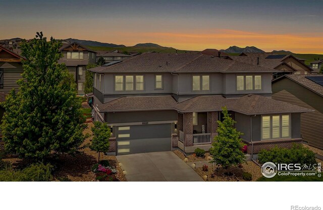 9527 Loveland Way, Arvada, CO 80007 - prairie-style house with concrete driveway, an attached garage, brick siding, and roof with shingles