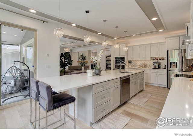 9527 Loveland Way, Arvada, CO 80007 - kitchen with stainless steel appliances, a sink, tasteful backsplash, recessed lighting, and pendant lighting