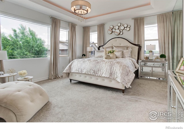 9527 Loveland Way, Arvada, CO 80007 - carpeted bedroom featuring a raised ceiling, baseboards, and a chandelier