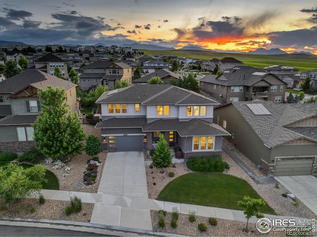 9527 Loveland Way, Arvada, CO 80007 - view of front facade featuring a residential view, concrete driveway, an attached garage, and stucco siding