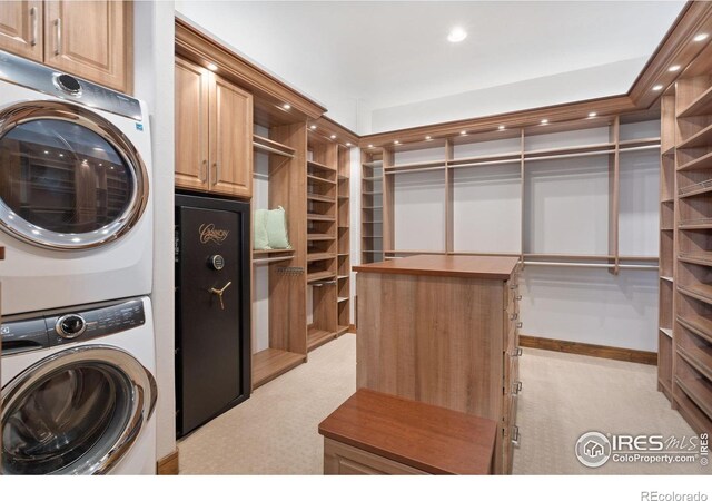 8236 County Road 74, Windsor, CO 80550 - laundry area featuring stacked washing machine and dryer, light colored carpet, cabinet space, and recessed lighting