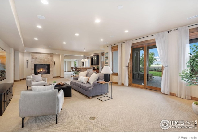8236 County Road 74, Windsor, CO 80550 - living area featuring light carpet, a fireplace, recessed lighting, and baseboards