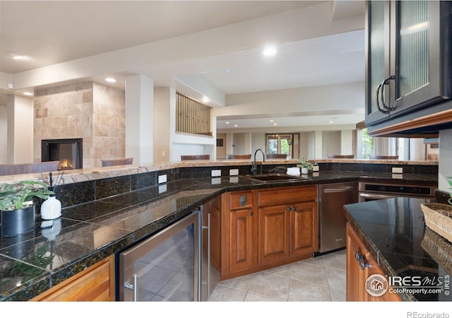 8236 County Road 74, Windsor, CO 80550 - kitchen featuring beverage cooler, a sink, brown cabinetry, open floor plan, and tile countertops