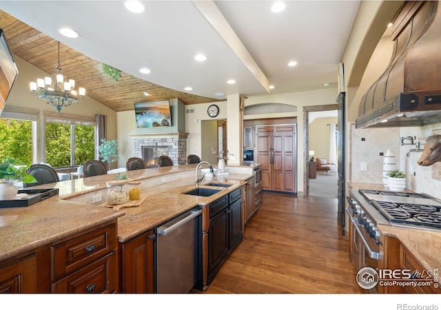 8236 County Road 74, Windsor, CO 80550 - kitchen with dishwasher, stovetop, wood finished floors, a sink, and light stone counters