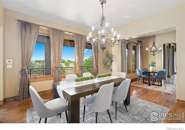 8236 County Road 74, Windsor, CO 80550 - dining area featuring a chandelier, wood finished floors, and baseboards