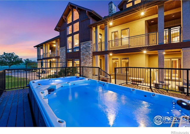 8236 County Road 74, Windsor, CO 80550 - pool at dusk with a hot tub