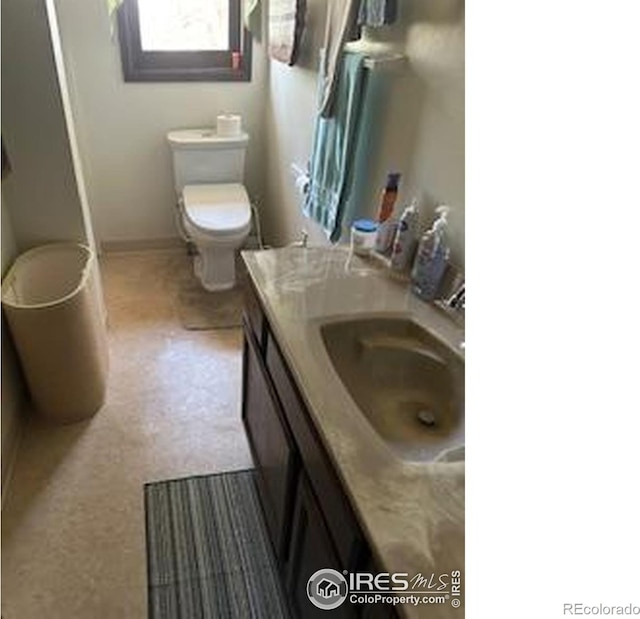 31888 County Road U, Brush, CO 80723 - bathroom featuring vanity, toilet, and baseboards