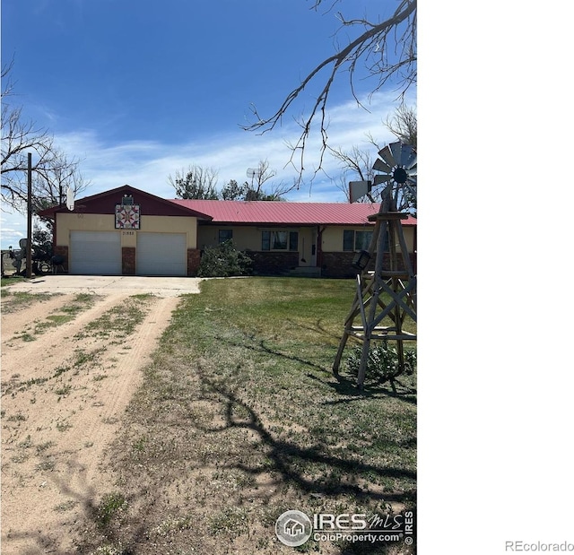 31888 County Road U, Brush, CO 80723 - ranch-style home with driveway, a garage, a front yard, metal roof, and brick siding