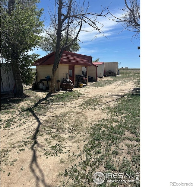 31888 County Road U, Brush, CO 80723 - view of home's exterior featuring driveway and an outbuilding