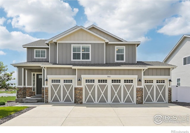961 Mouflon Dr, Severance, CO 80550 - craftsman-style home featuring stone siding, board and batten siding, an attached garage, and concrete driveway