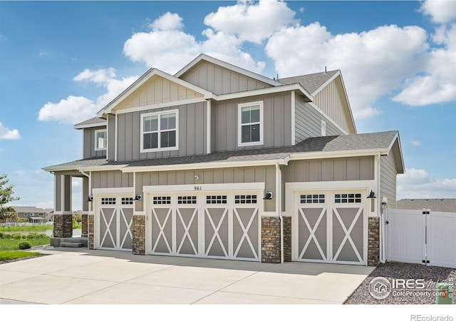 961 Mouflon Dr, Severance, CO 80550 - craftsman inspired home with stone siding, a garage, a shingled roof, and driveway