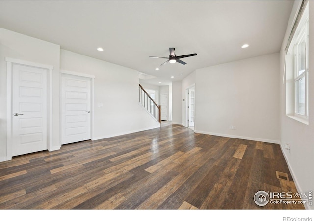 961 Mouflon Dr, Severance, CO 80550 - unfurnished living room with dark wood-type flooring, stairs, a ceiling fan, recessed lighting, and baseboards