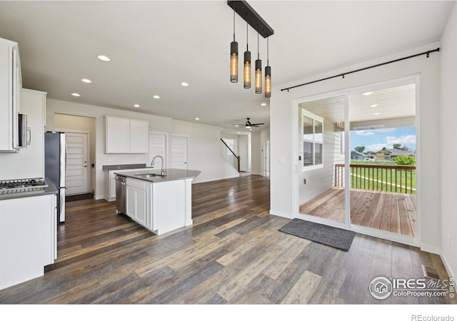 961 Mouflon Dr, Severance, CO 80550 - kitchen featuring a sink, dark countertops, dark wood-style flooring, stainless steel appliances, and recessed lighting