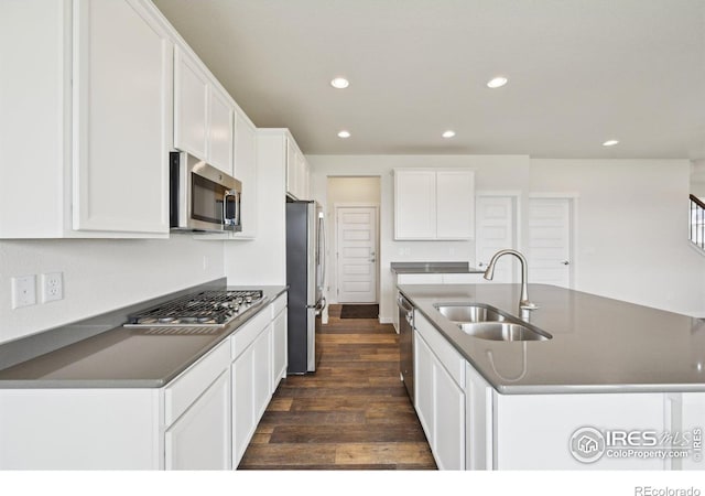 961 Mouflon Dr, Severance, CO 80550 - kitchen featuring appliances with stainless steel finishes, a sink, dark countertops, recessed lighting, and dark wood-style floors