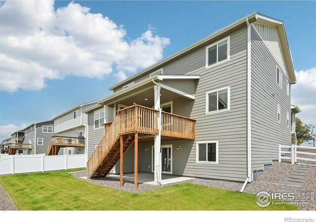 961 Mouflon Dr, Severance, CO 80550 - back of property featuring a wooden deck, stairway, and a patio area