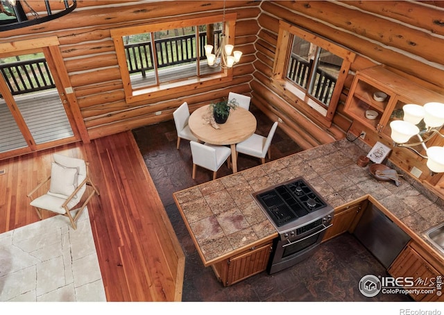 28 Ute Crossing Ct, Lyons, CO 80540 - living area with rustic walls, a chandelier, and wood finished floors