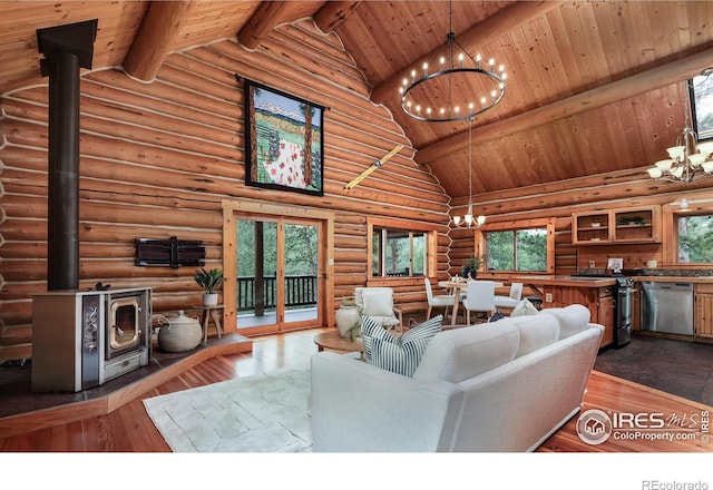 28 Ute Crossing Ct, Lyons, CO 80540 - living room with a chandelier, a wood stove, high vaulted ceiling, wooden ceiling with exposed beams, and plenty of natural light