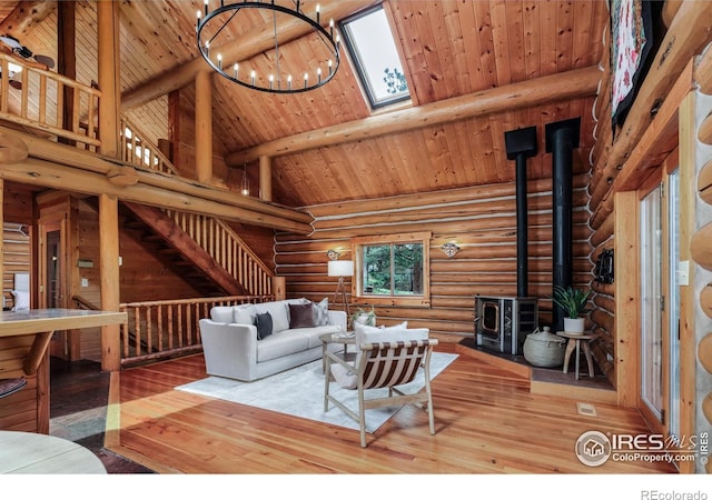 28 Ute Crossing Ct, Lyons, CO 80540 - living area featuring a wood stove, wood-type flooring, wooden ceiling with exposed beams, log walls, and high vaulted ceiling