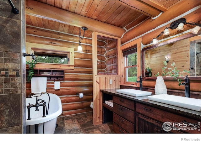 28 Ute Crossing Ct, Lyons, CO 80540 - bathroom featuring double vanity, wood ceiling with exposed beams, rustic walls, stone finish floors, and toilet