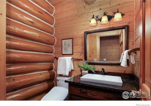 28 Ute Crossing Ct, Lyons, CO 80540 - half bath with vanity, toilet, and wooden walls