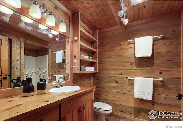 28 Ute Crossing Ct, Lyons, CO 80540 - bathroom featuring wood walls, vanity, toilet, and wood ceiling