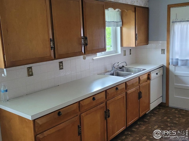 1918 Sumac Pl, Longmont, CO 80501 - kitchen featuring a sink, white dishwasher, backsplash, light countertops, and brown cabinets