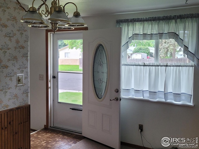 1918 Sumac Pl, Longmont, CO 80501 - foyer with wallpapered walls, a chandelier, and a wainscoted wall