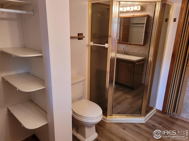 1918 Sumac Pl, Longmont, CO 80501 - full bath with wood finished floors, toilet, a shower stall, and vanity