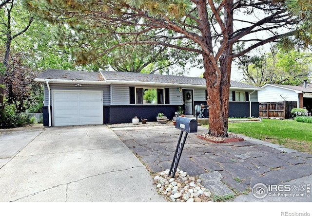 1405 Village Ln, Fort Collins, CO 80521 - ranch-style house with a garage, concrete driveway, and brick siding