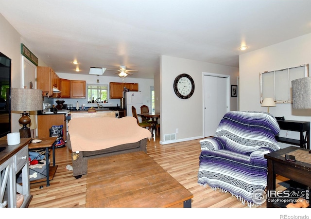 1405 Village Ln, Fort Collins, CO 80521 - living room featuring light wood-type flooring, a ceiling fan, and baseboards