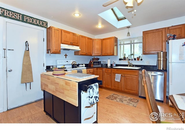 1405 Village Ln, Fort Collins, CO 80521 - kitchen with white appliances, under cabinet range hood, a skylight, a sink, and a ceiling fan